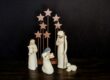 three religious figurines on brown surface